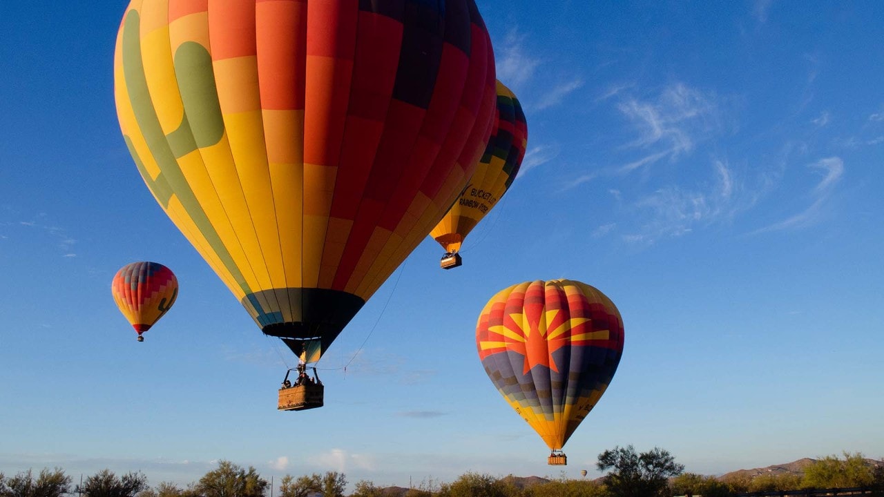 Colorful balloons take off from the Sonoran Desert.