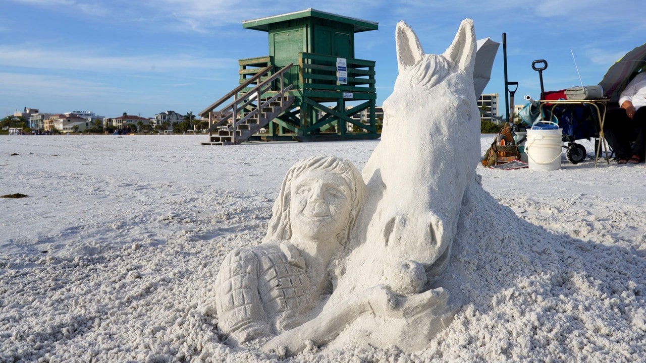 A whimsical sand sculpture greets visitors to Siesta Key Beach.
