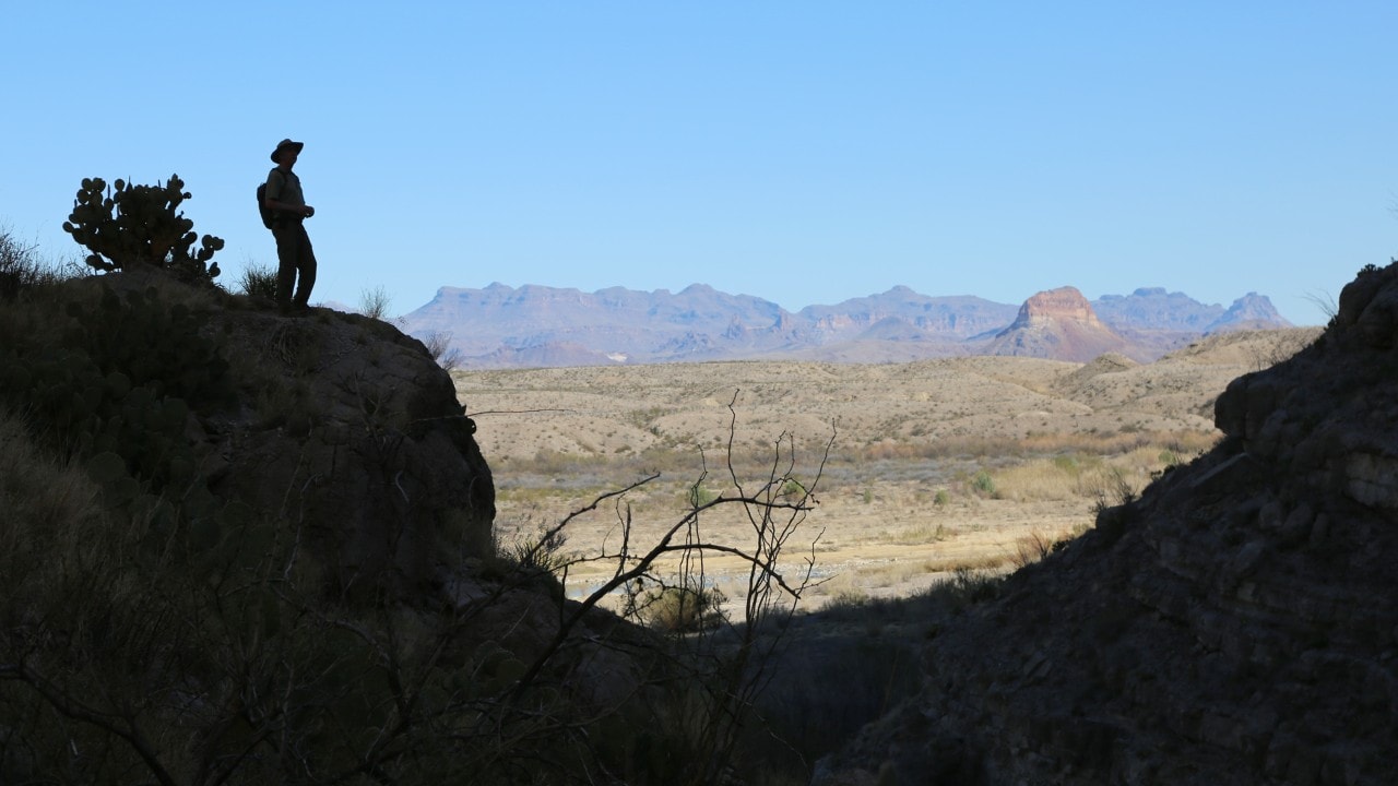 A hiker looks down on the Rio Grande River in the Santa Elena Canyon.
