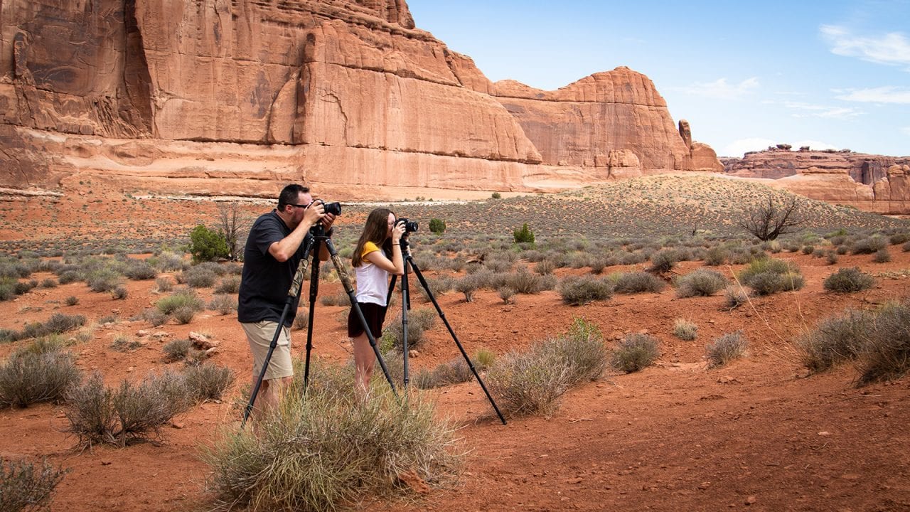 Derek and Karlie photograph in Arches National Park.