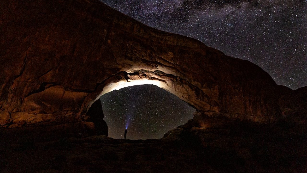Karlie's headlamp lights up North Window Arch in Arches National Park