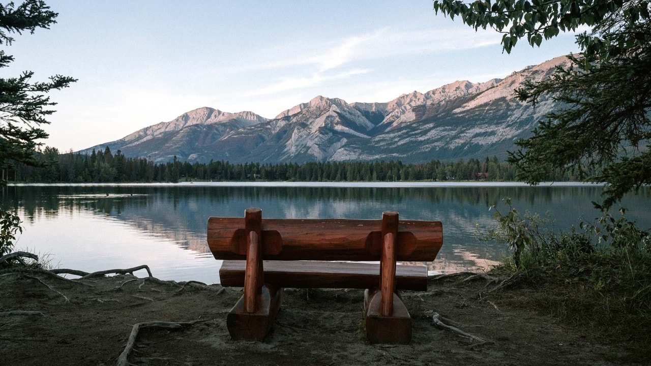 A bench overlooks Annette Lake in Jasper National Park.