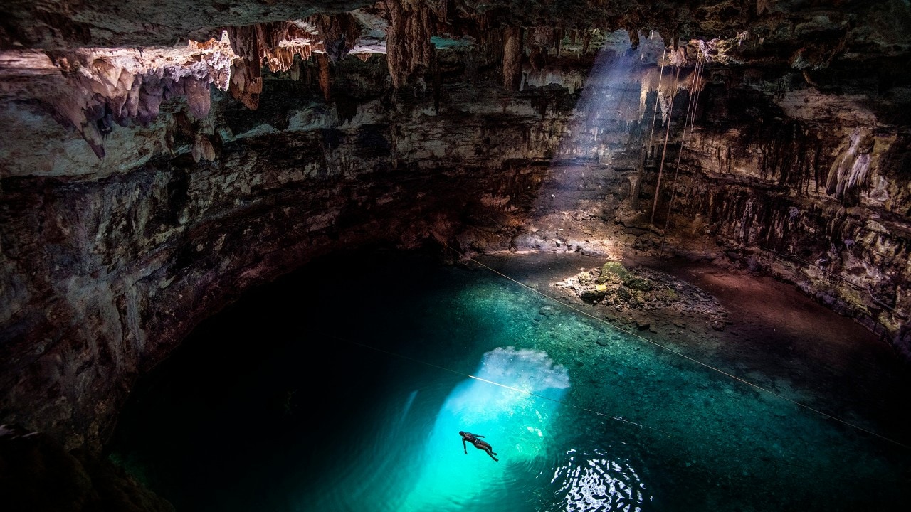 Kassondra takes a sightseeing break to relax in Cenote Samula, located in Yucatan.