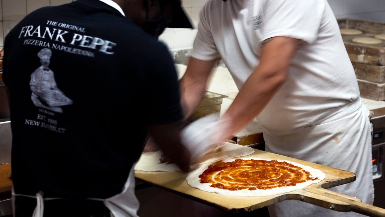 Workers prepare pizzas at Frank Pepe Pizzeria Napoletana.