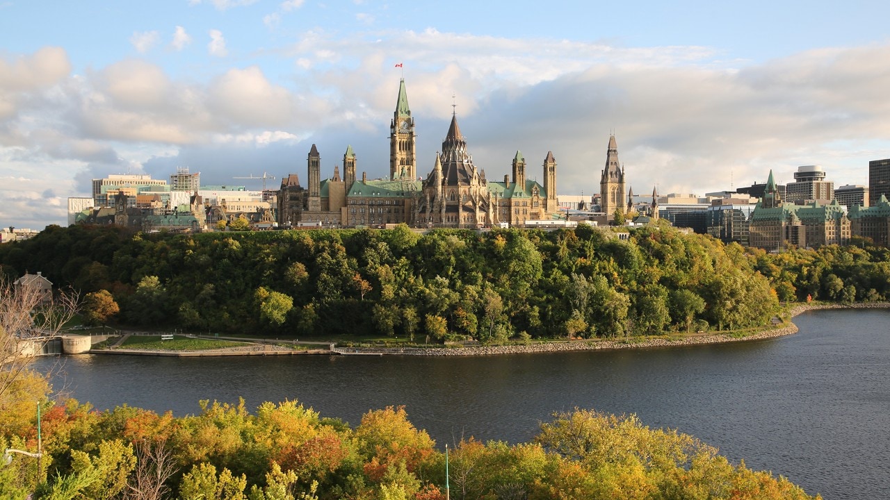 The Parliament buildings rise above the Ottawa River in this view from the Samuel de Champlain statue.