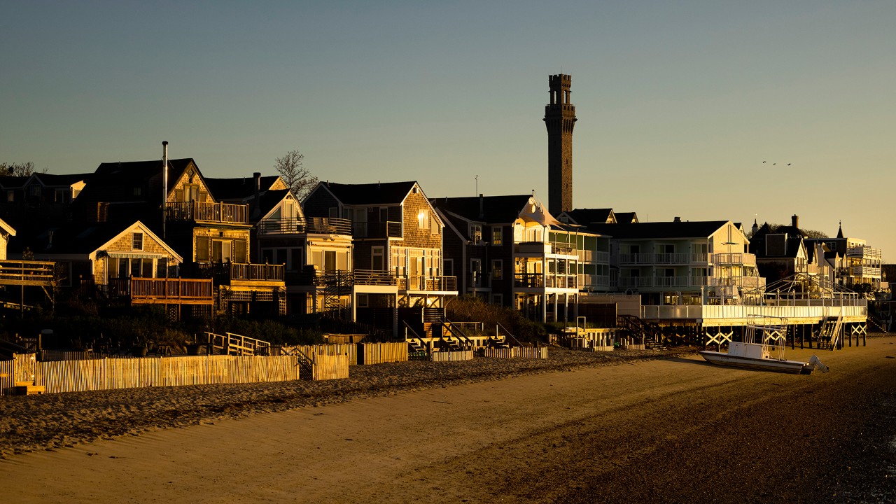 The 252-foot Pilgrim Monument rises above a row of homes in Provincetown.