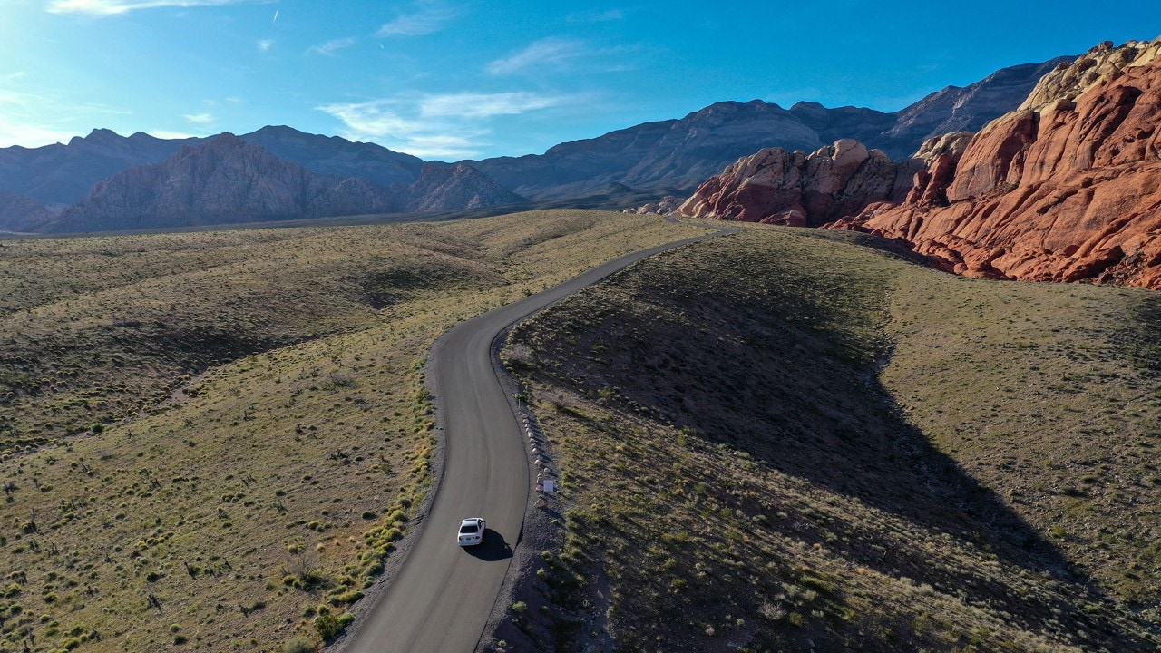A car drives on Red Rock Canyon's 13-mile scenic drive.