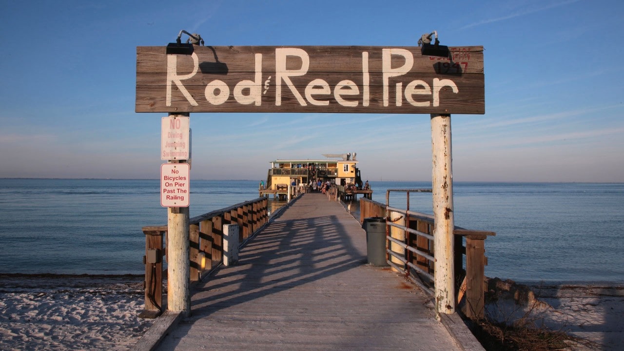 The pier's hand-painted sign indicates that anything more than flip-flops are out of place.