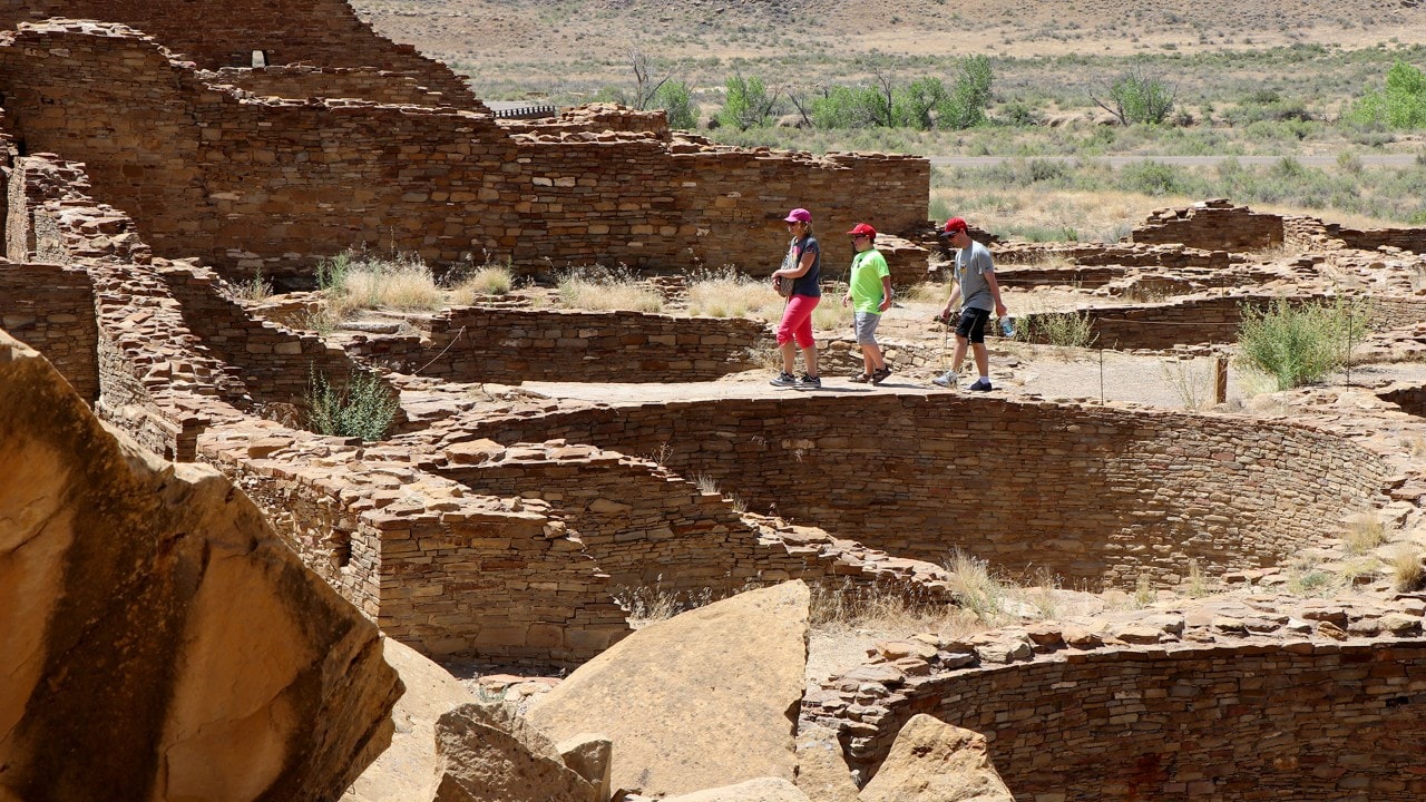 Visitors follow designated paths that lead into the ruins.