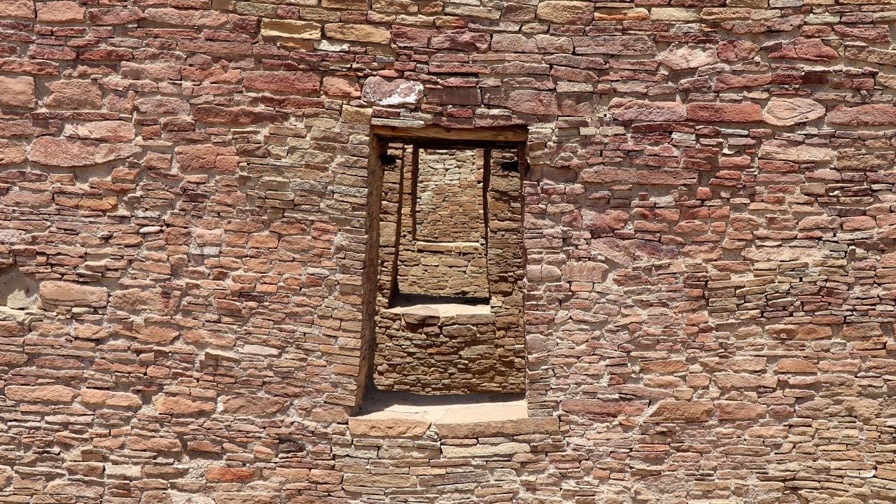 The windows and doors are aligned within the stone walls