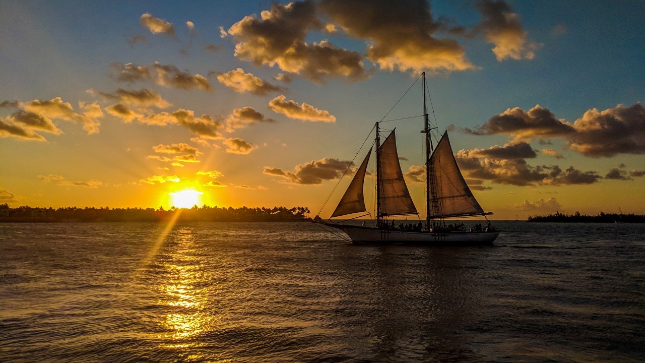 A boat passes by Sunset Pier in Key West, Florida.