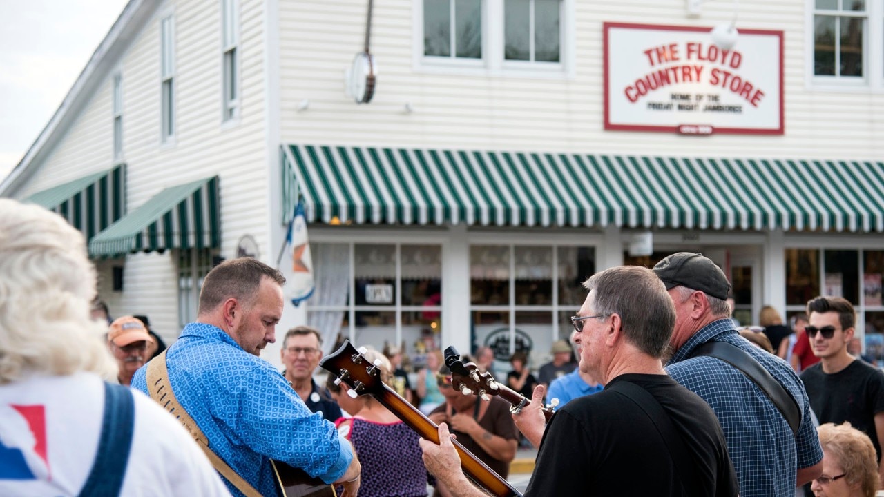 Nuthin' Common bandmates, Mark and Dwight Vaughn along with Anthony Blackburn play to a crowd outside of the Floyd Country Store during the Floyd Friday Night Jamboree.