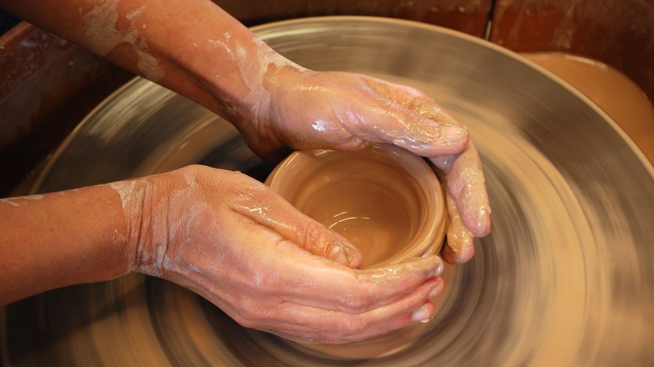 The author gets her hands dirty in clay at the Ohr-O’Keefe Museum of Art.