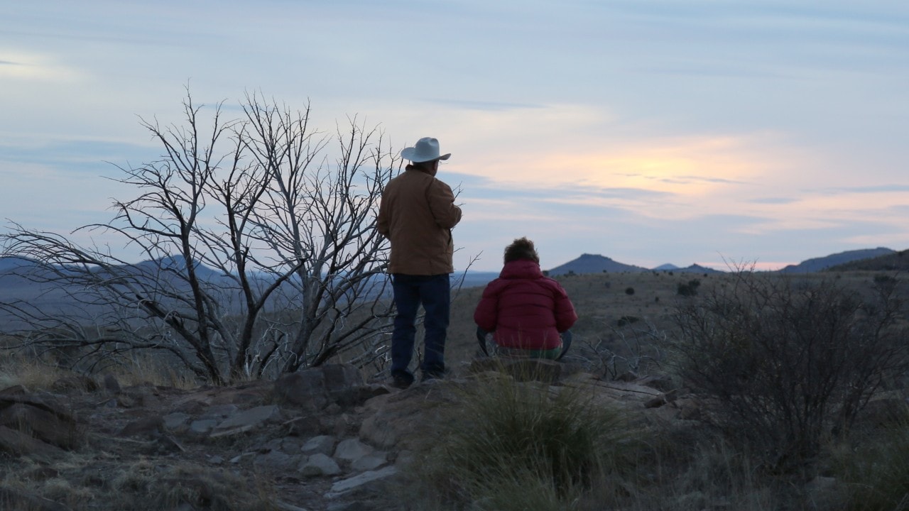 A couple views the sunset at Davis Mountains State Park.
