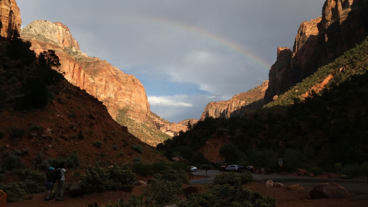 Visitors photograph a rainbow that appeared after a storm.
