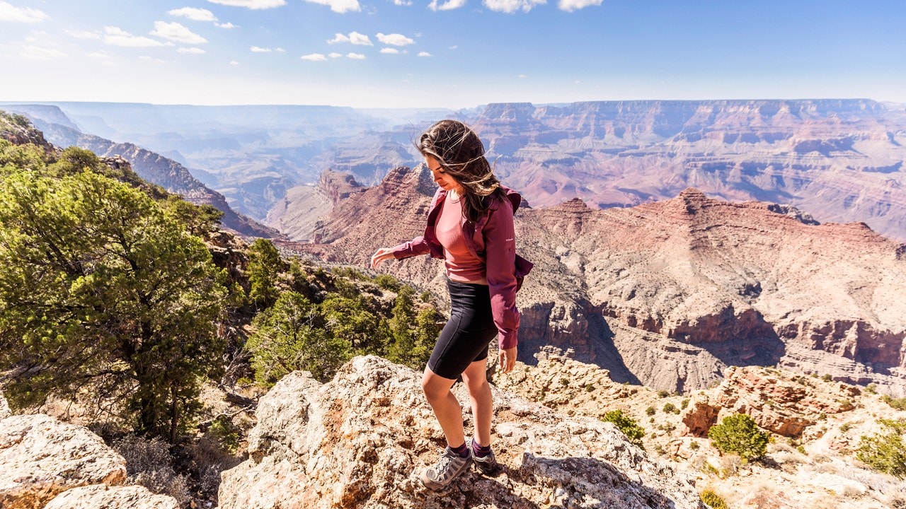 Sarah Lozano hikes along the edge of the Grand Canyon near the Desert View Watchtower.