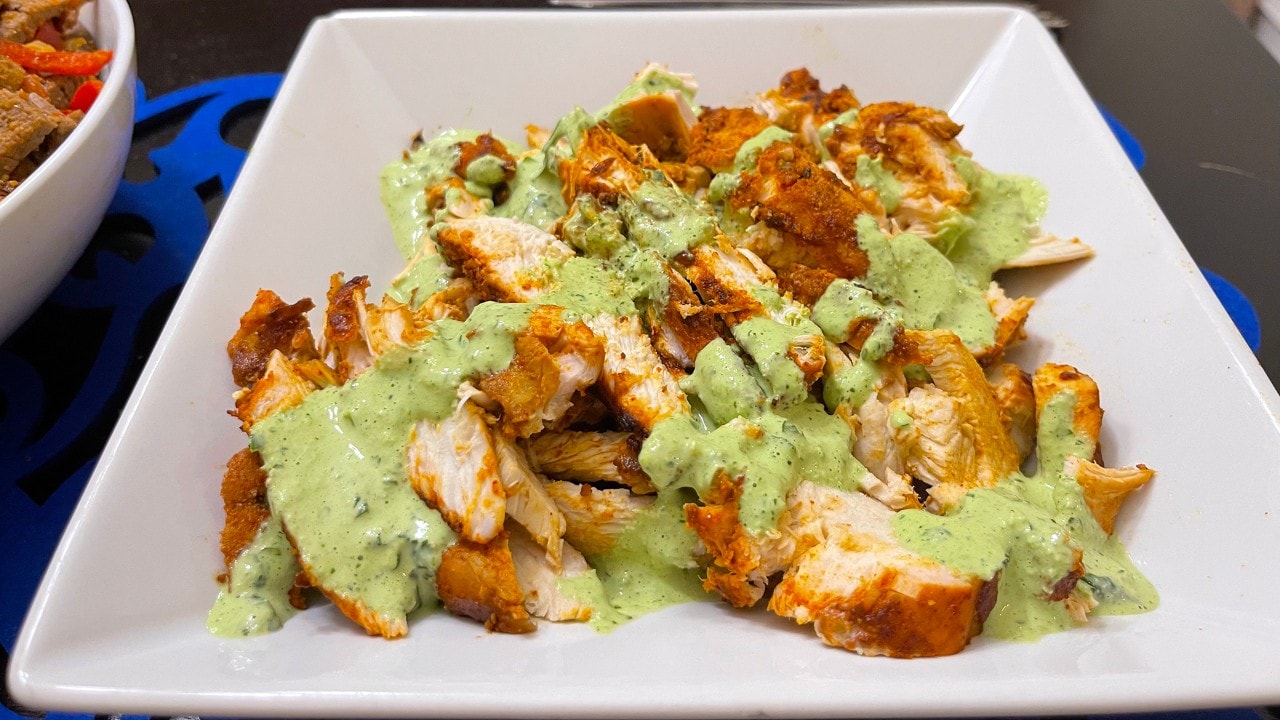 Aji Verde, a creamy green sauce, is traditionally served over Peruvian chicken. 