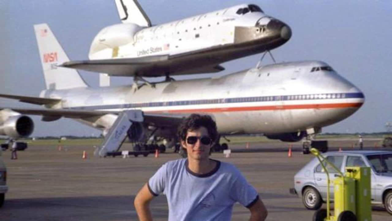 The author stands in front of the new space shuttle Challenger, which stopped in 1982 at Ellington Air Force Base in Houston.