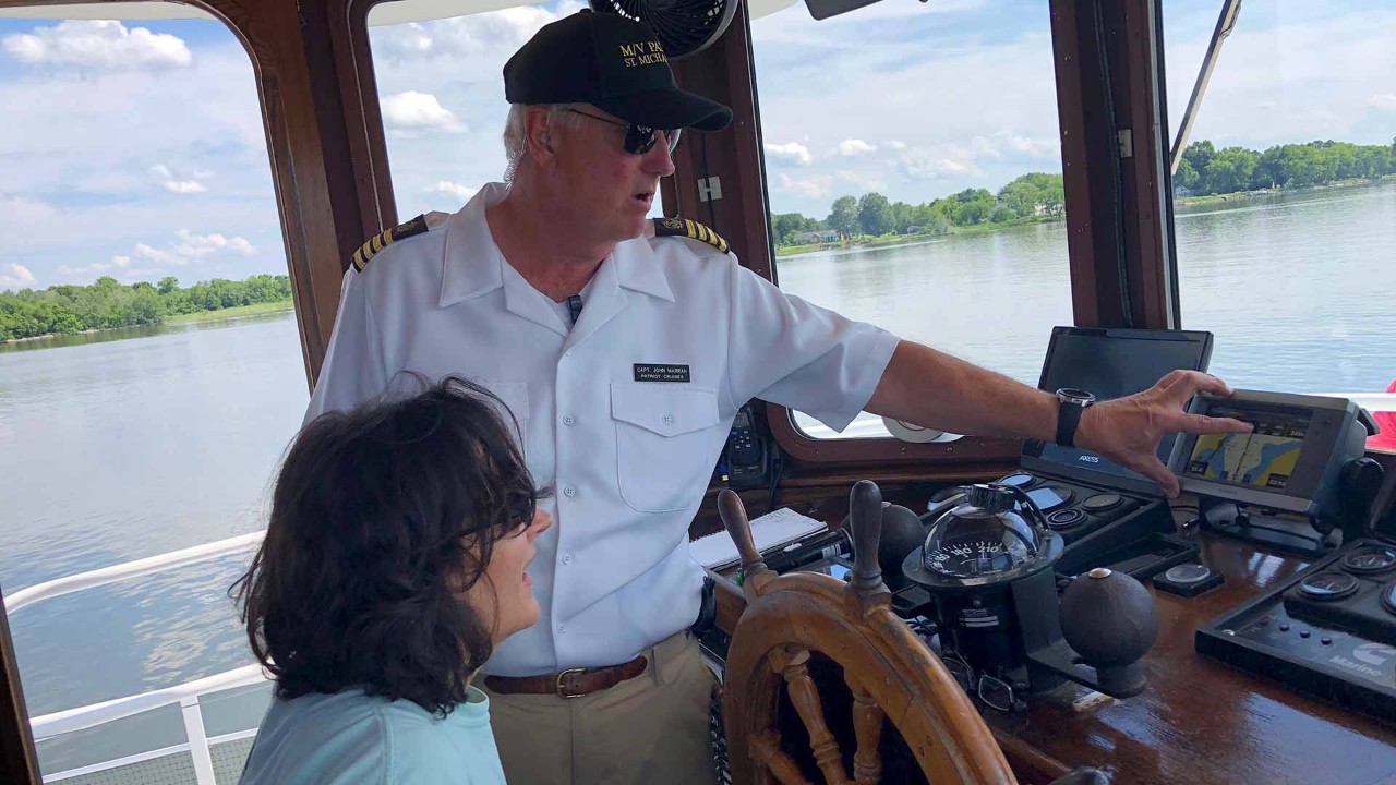 Captain John Marrah shows Lauren the pilot room of the Patriot cruise boat