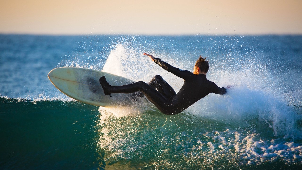 An expert surfer rides a wave at Topanga Beach.