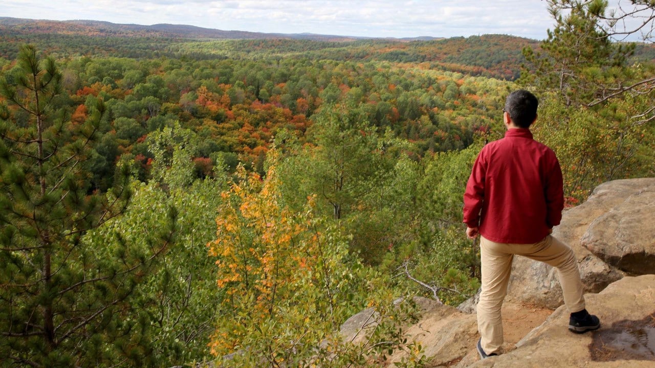 A visitor admires the view at the Lookout Trail overlook.