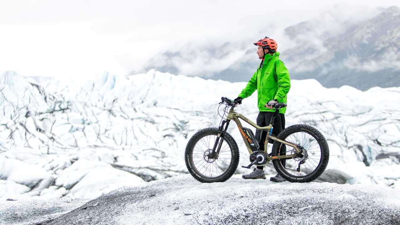 A mountain biker enjoys the view at Matanuska Glacier in Alaska.
