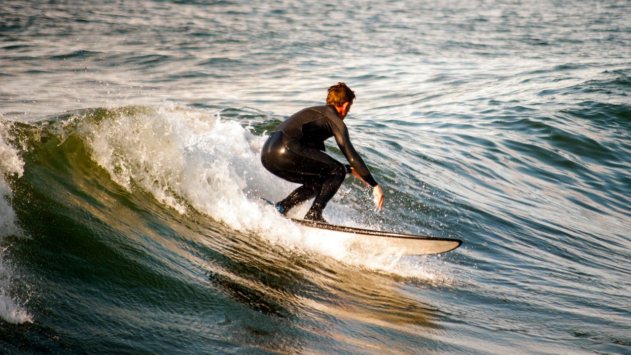 A surfer challenges "The Groins" in Westport, Washington.