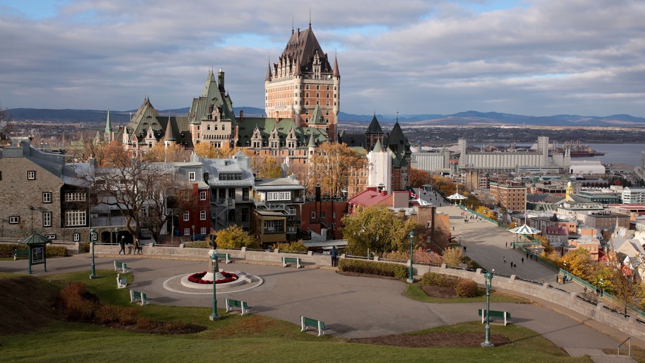 From Bastion de la Reine Park, the Fairmont Le Chateau Frontenac dominates the skyline. The Terrasse Dufferin walkway is seen on the lower right.