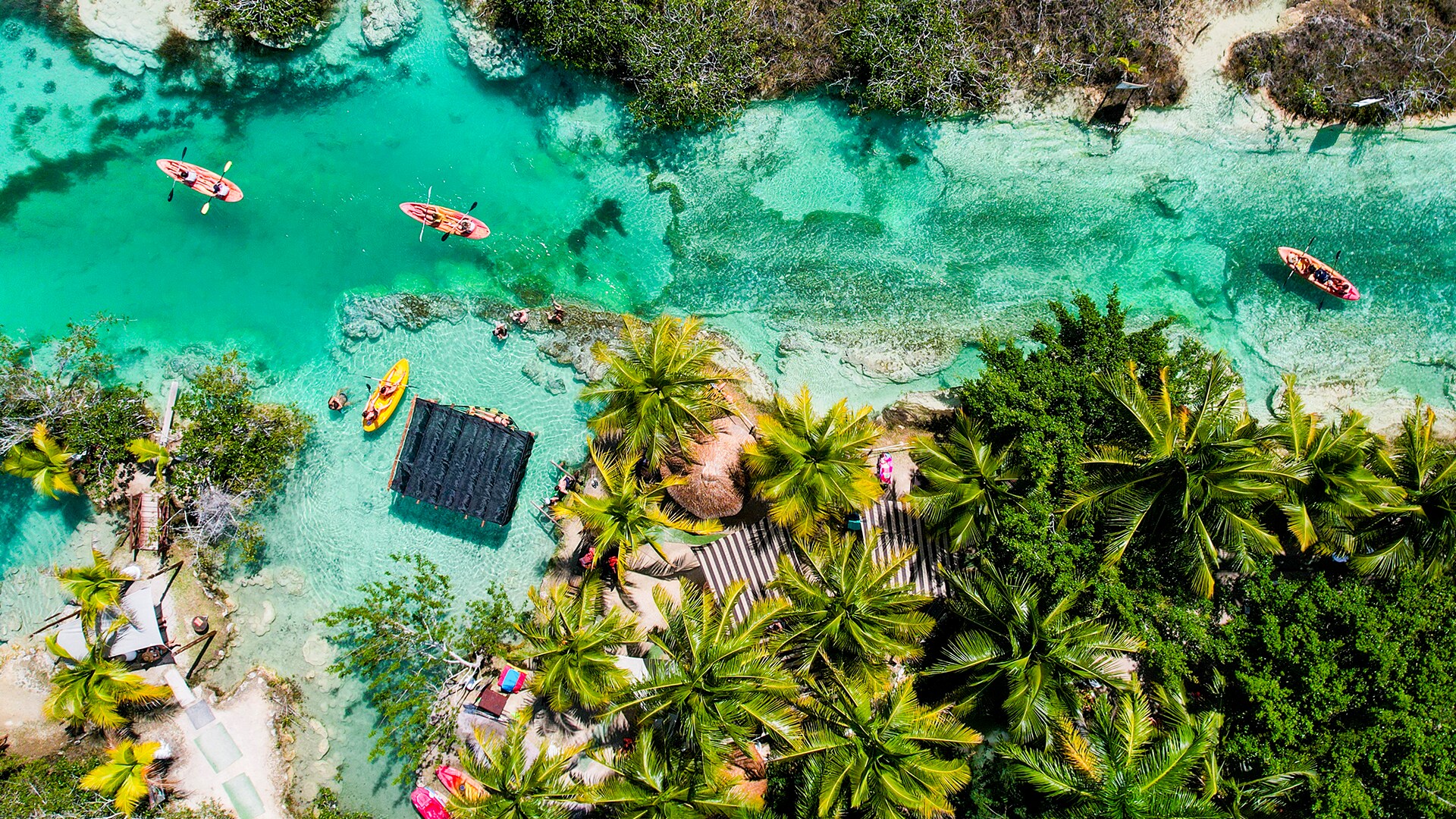 Kayakers paddle at Los Rapidos, a narrow strip of water that connects two large sections of Bacalar Lagoon.