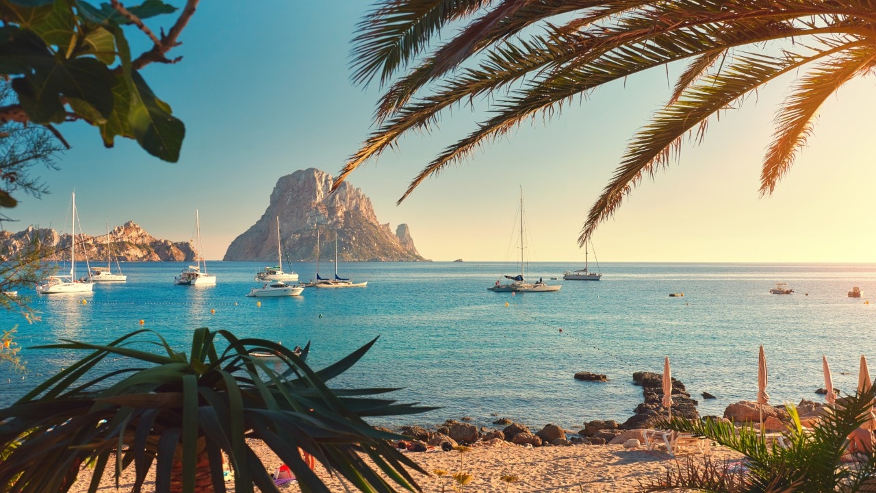 Cala d'Hort beach. Cala d'Hort in summer is extremely popular, beach have a fantastic view of the mysterious island of Es Vedra. Ibiza Island, Balearic Islands. Spain