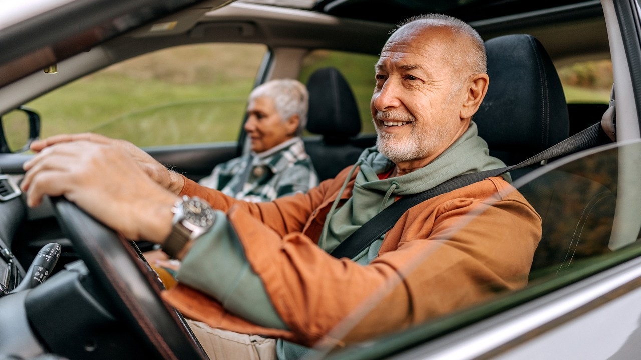 Senior couple on a road trip in a car together