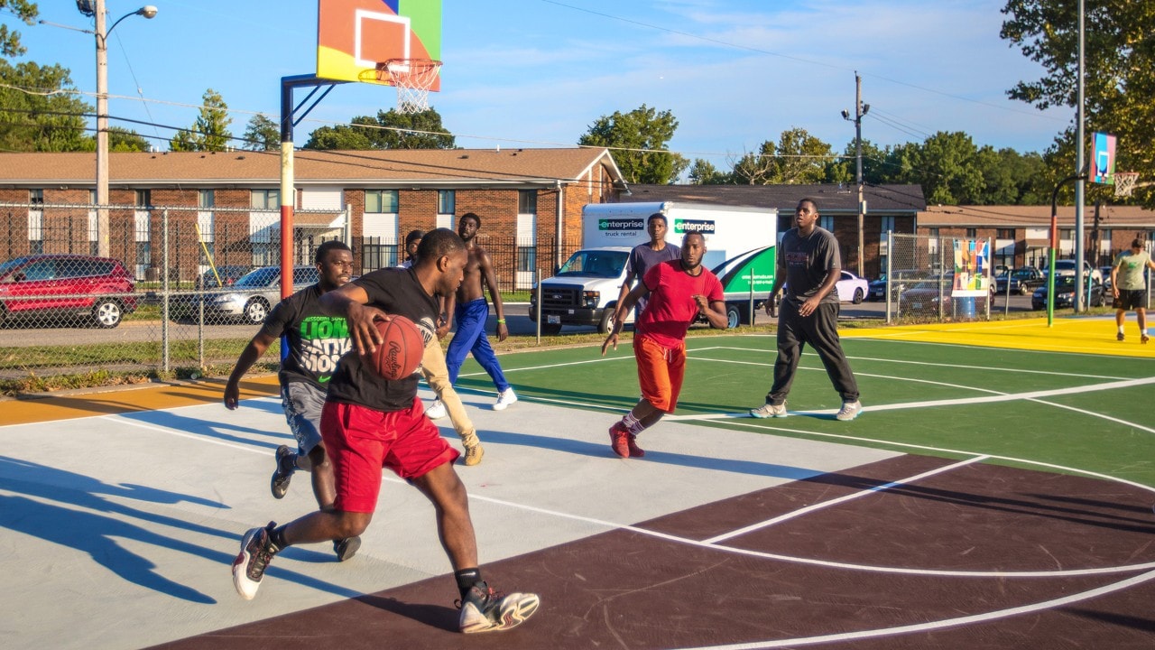 Community members play pick up hoops.