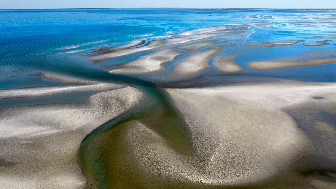 Sand bars stretch into Cape Cod Bay at low tide.