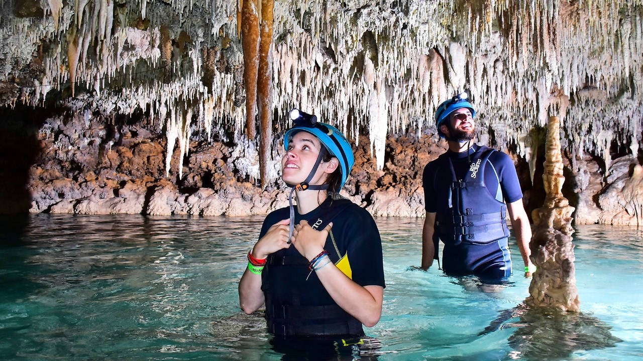 Writer Kassondra Cloos looks at stalactites hanging in the Rio Secreto cave in Playa del Carmen. Photo courtesy of Michael Ciaglo
