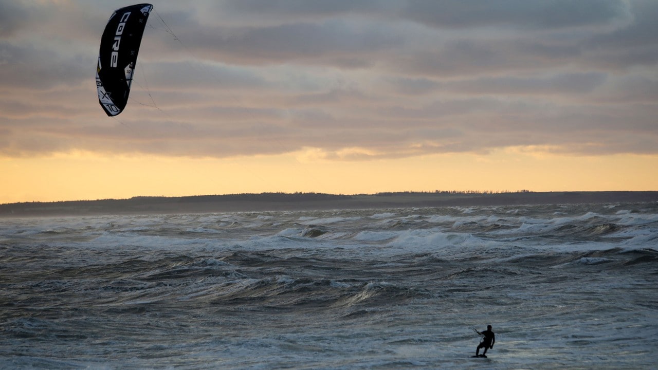 A windsurfer challenges the waves on the north shore.