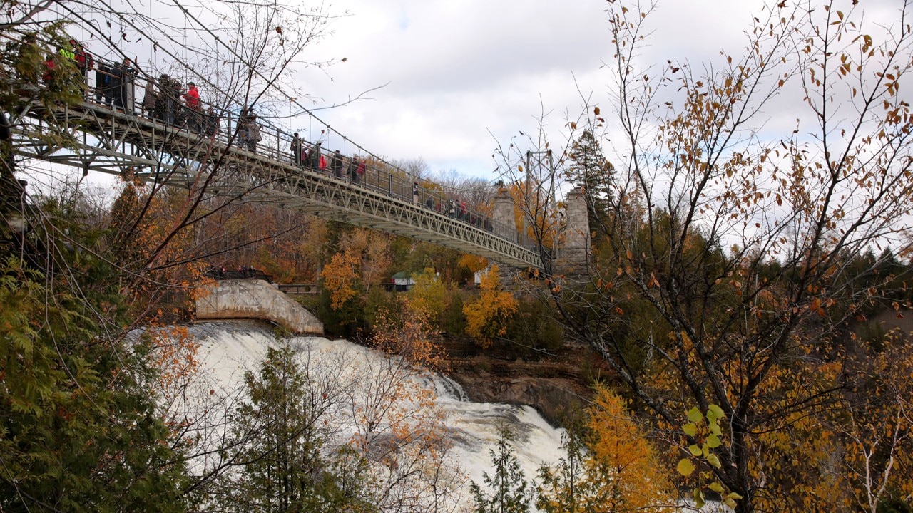 A suspension bridge spans the falls.