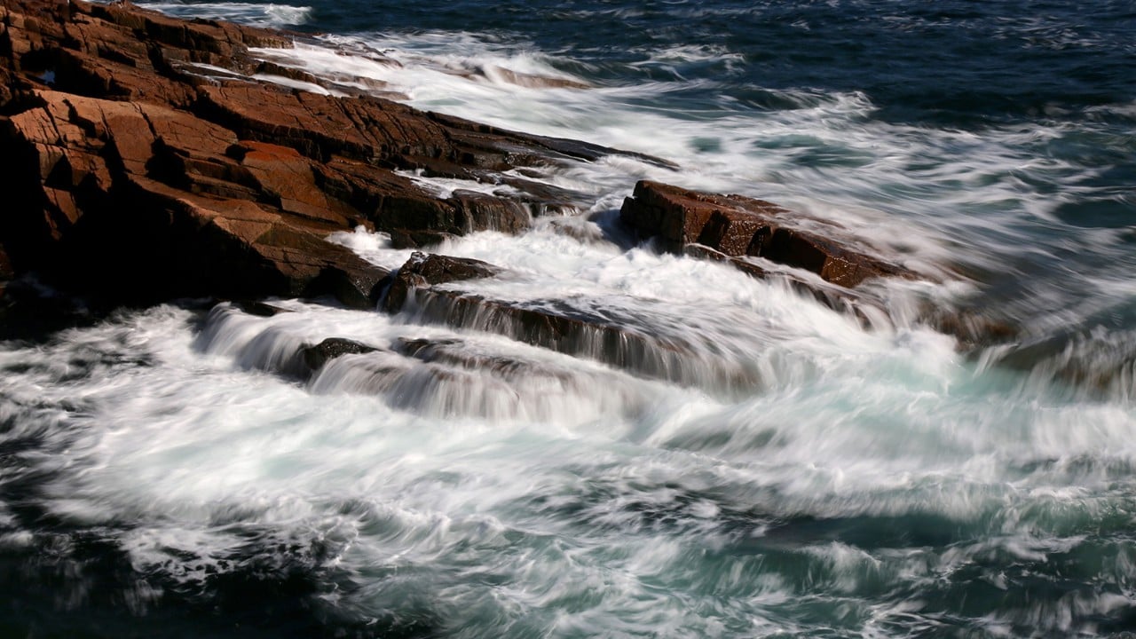 Waves crash into Acadia National Park's shoreline. Photo by Charles Williams