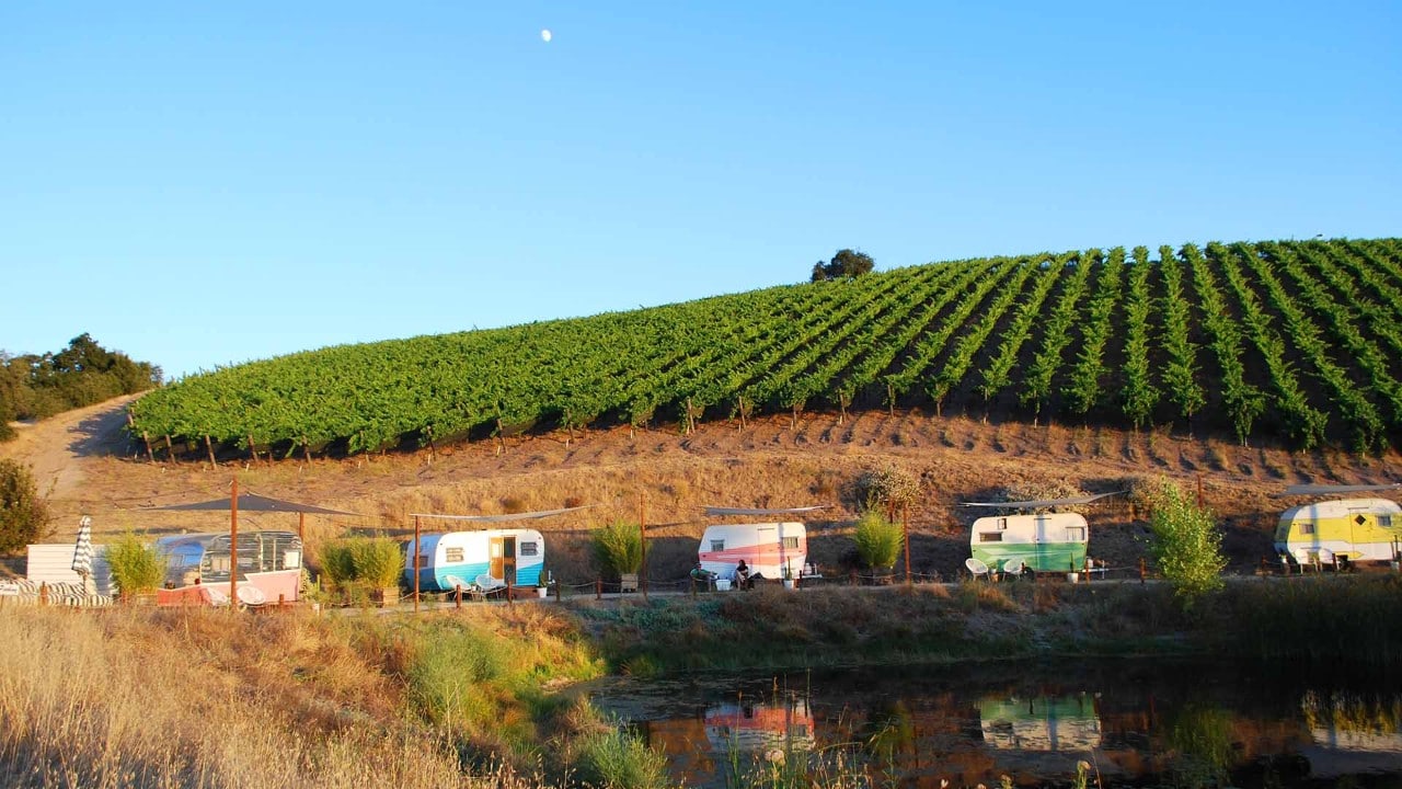 Tinker Tin vintage trailers line a pond at Alta Colina winery.