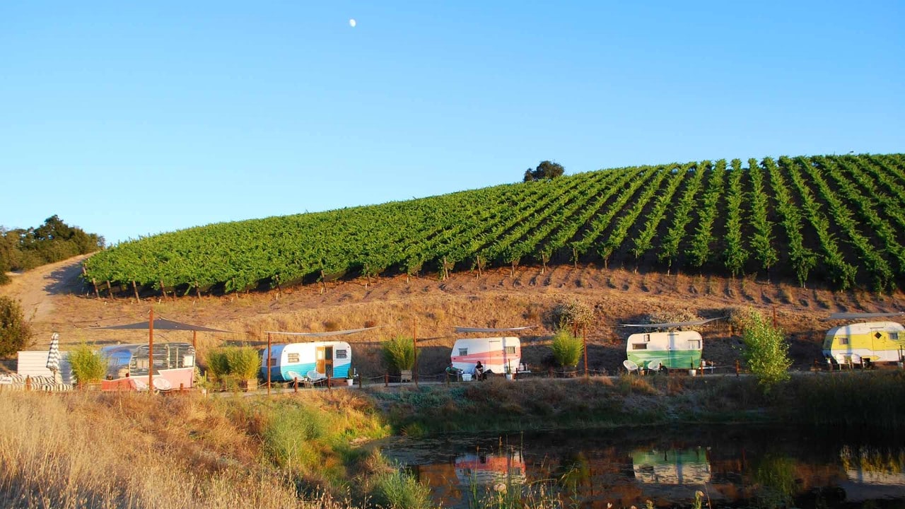 Tinker Tin vintage trailers line a pond at Alta Colina winery.