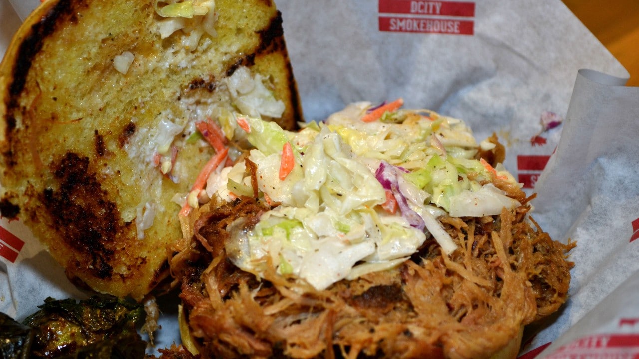 Coleslaw piled on top of a juicy pulled pork sandwich at DCity Smokehouse