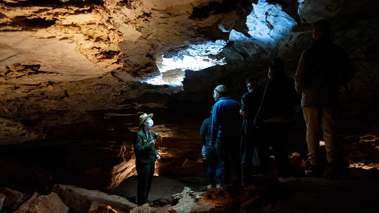 A ranger highlights honeycomb-like patterns of boxwork during a tour of Wind Cave’s vast chambers. 