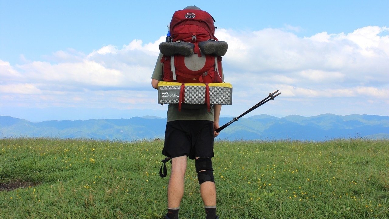 Hiker Matt, also known on the trail as Ulysses, stops to enjoy the beautiful view from Max Patch. Photo by Emanuel Vinkler