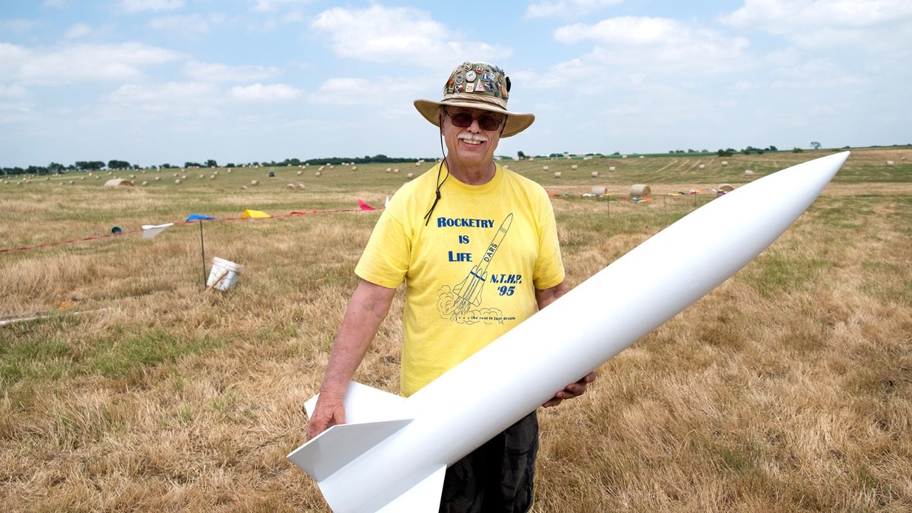 Jack Sprague, president of the Dallas Area Rocket Society, shows off his minimalist, all-white model rocket. 