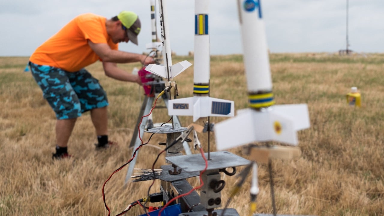 A row of small models built by the Dallas Area Rocket Society are prepared for liftoff. 