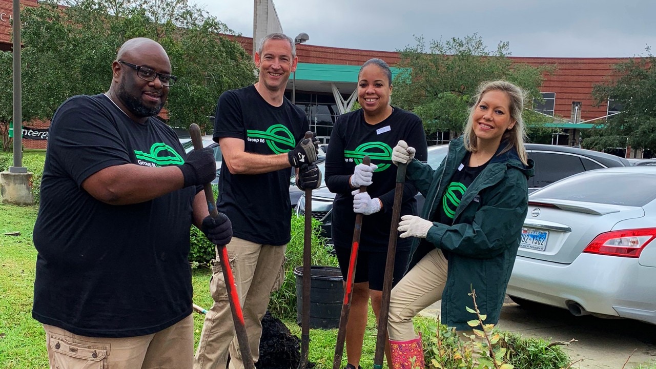Employees take a break from planting to pose for a photo.
